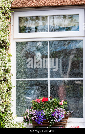 Belfast, UK, Europe. 16th July 2016. Two bullet holes in the double glazed window after a Gun Attack at on House in West Belfast Credit:  Bonzo/Alamy Live News Stock Photo