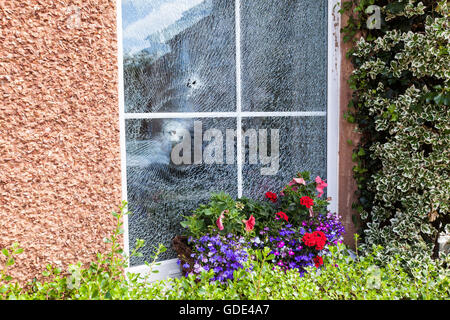 Belfast, UK, Europe. 16th July 2016. Two bullet holes in the double glazed window after a Gun Attack at on House in West Belfast Credit:  Bonzo/Alamy Live News Stock Photo