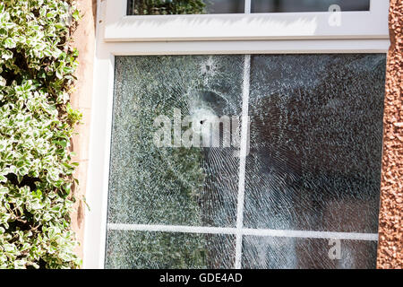 Belfast, UK, Europe. 16th July 2016. Two bullet holes in the double glazed window after a Gun Attack at on House in West Belfast Credit:  Bonzo/Alamy Live News Stock Photo