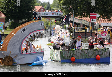 Plau am See, Germany. 16th July, 2016. Participants in the 'Badewannenrallye' (lit. bath tub rally) in Plau am See, Germany, 16 July 2016. The rafts have to stay afloat over a set distance, then the most imaginative vessels win prizes. Credit:  dpa picture alliance/Alamy Live News Stock Photo
