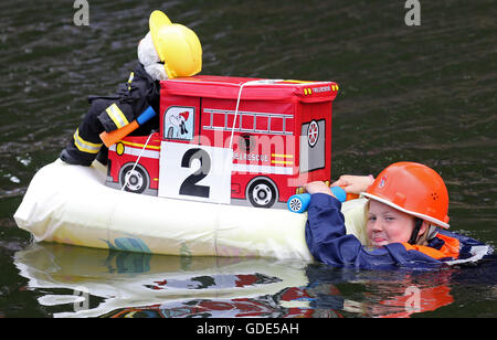Plau am See, Germany. 16th July, 2016. Laura Moeller from the Goldberg youth fire brigade pictured with her vessel during the 'Badewannenrallye' (lit. bath tub rally) in Plau am See, Germany, 16 July 2016. The rafts have to stay afloat over a set distance, then the most imaginative vessels win prizes. Credit:  dpa picture alliance/Alamy Live News Stock Photo