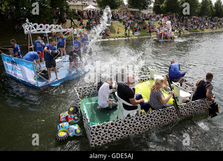 Plau am See, Germany. 16th July, 2016. Participants engage in water fights during the 'Badewannenrallye' (lit. bath tub rally) in Plau am See, Germany, 16 July 2016. The rafts have to stay afloat over a set distance, then the most imaginative vessels win prizes. Credit:  dpa picture alliance/Alamy Live News Stock Photo