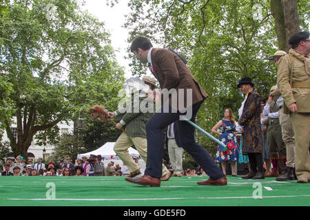 London, 16th July 2016. Contestants dressed in eccentric clothes attend the Chap Olympiad in Bedford Square London to celebrate Britain's Sporting ineptitude, involving  track and field events including  The Tea Pursuit on bicycles, Well Dressage and Umbrella Jousting with points awarded for style Credit:  amer ghazzal/Alamy Live News Stock Photo