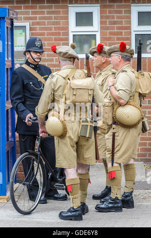 Woodhall Spa, Lincolnshire, UK. 16th July, 2016. The fifth annual Woodhall Spa 1940s Festival attracts 20,000 visitors over the weekend as it celebrates the best of life on the British Home Front of World War Two in the 1940s. Following an opening Remembrance Service in the village Church Yard the day unfolded with Military Wives Choir and 1940s performers plus a World War Two re-enactment group ‘digging in' and living in the woods for the weekend. Credit:  Matt Limb/Alamy Live News Stock Photo