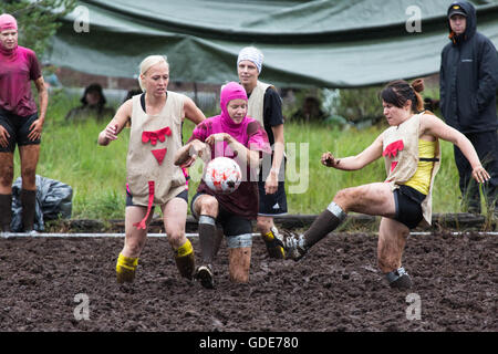 Hyrynsalmi, Finland, July 16 2016. The Swamp Soccer World Championship 2016 at Ukkohalla in Hyrnsalmi. About 2000 competitors take part every year in the world’s oldest swamp soccer tournament. Pictured: Action and crowd scenes from the knockout stages on the rainy second day. Credit:  Rob Watkins/Alamy Live News Stock Photo