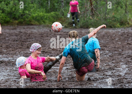 Hyrynsalmi, Finland, July 16 2016. The Swamp Soccer World Championship 2016 at Ukkohalla in Hyrnsalmi. About 2000 competitors take part every year in the world’s oldest swamp soccer tournament. Pictured: Action and crowd scenes from the knockout stages on the rainy second day. Credit:  Rob Watkins/Alamy Live News Stock Photo