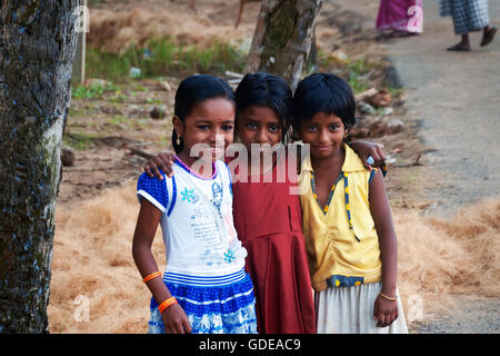 Unidentified three Indian girls on the street in fishing village. Kovalam. Kerala. India Stock Photo