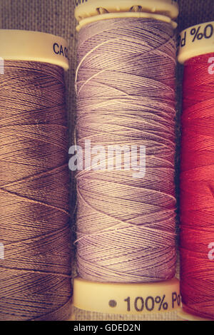 Spools of thread in a retro vintage style. Vertical image. Stock Photo