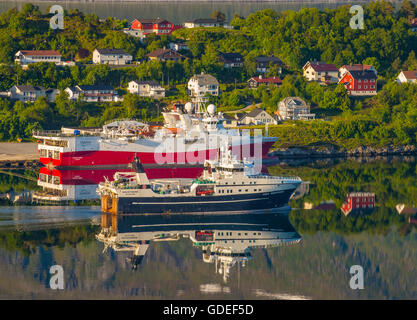 View of Colorful Fishing Trawlers anchored in Outer Fjord, Alesund, Norway, More Og Romsdal. Scandinavia Stock Photo