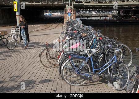 Cyclist outside Ceentral - Central Railway Station; Amsterdam; Holland; Stock Photo