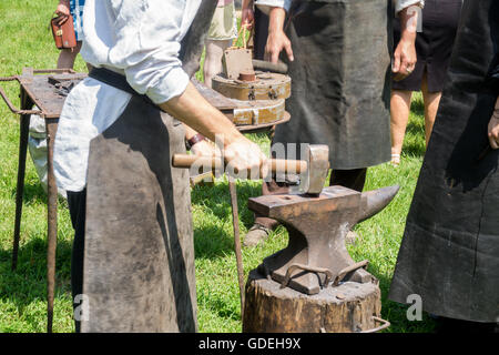 An anvil is a block with a hard surface on which hammer is struck. They are used for the manufacture of metal products Stock Photo