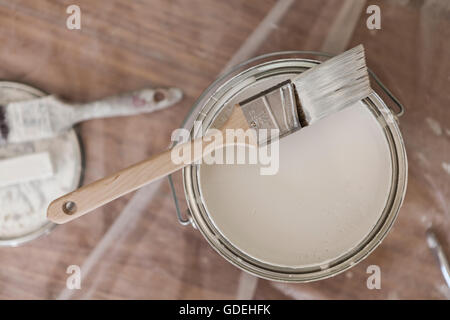 Paint brush resting on paint tin viewed from above Stock Photo