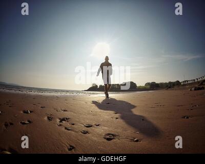 Silhouette of man running on beach Stock Photo