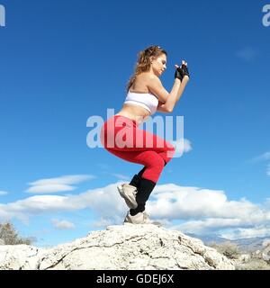Woman doing an eagle yoga pose in the desert, Nevada, United States Stock Photo