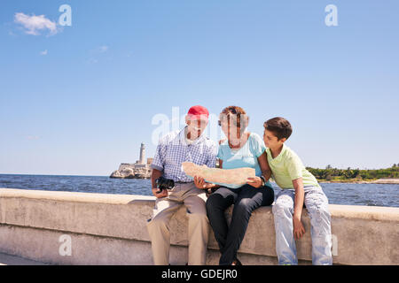 Happy tourist family on holidays, during vacation journey in Cuba. Hispanic grandpa, grandma and grandson traveling in Havana Stock Photo