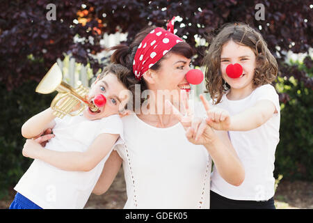 Mother, son and daughter dressed as clowns Stock Photo