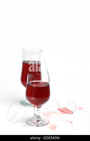 Broken glass with wine and drops ,isolated on white background Stock Photo