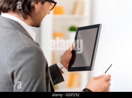 Positive businessman using tablet Stock Photo