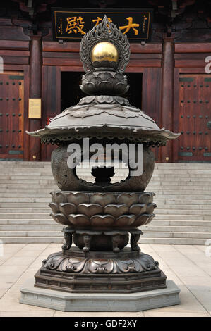 An incense burner in front of a the Grand hall at Baoshan Buddhist Temple in Baoshan district Shanghai China. Stock Photo