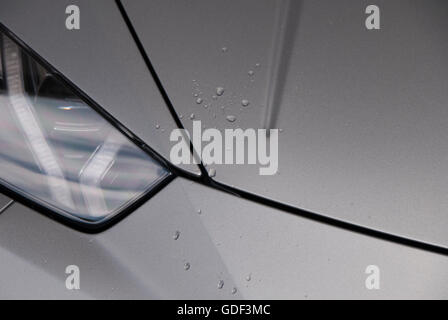 Image of a car wing with droplets of rain on the surface Stock Photo