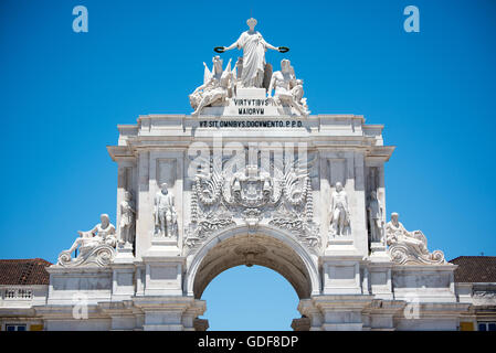 LISBON, Portugal — Detail of the Arco da Rua Augusta, a triumphal arch on Praça do Comércio (Commerce Square) in Lisbon's Pombaline Downtown district. Built to commemorate the city's rebuilding after the 1755 earthquake, the arch features ornate sculptures and architectural details. Atop the arch, sculptures represent Glory rewarding Valor and Genius, symbolizing Lisbon's resilience and renaissance. Stock Photo