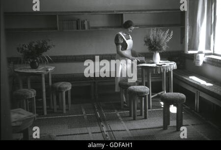 1930s, historical, a female nurse in a waiting area for unmarried mothers run by the Sudeten German Party, the Sdp, in Lauterbach, in the Sudetenland, pre-WW11 Czechoslovakia. Stock Photo