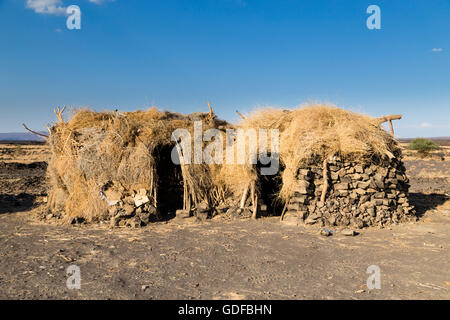 Huts in the Afar settlement at the foot of the active volcano Erta Ale, Danakil Depression, Afar Triangle, Ethiopia Stock Photo