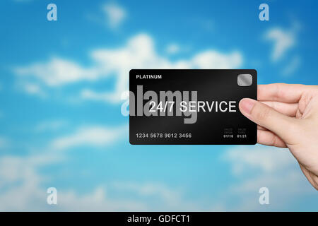 hand picking 24 hours a day, 7 days a week service platinum card on blur background Stock Photo