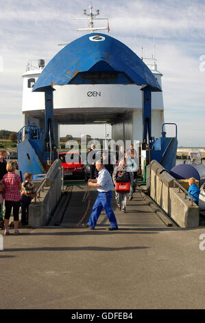 A small ferry line, passengers and cars boarding and leaving the ferry Stock Photo