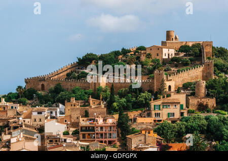 Capdepera castle on green hill in Mallorca island, Spain. Beautiful landscape with medieval architecture in Majorca Stock Photo