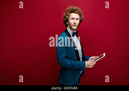 Young stylish man in suit with tablet Stock Photo