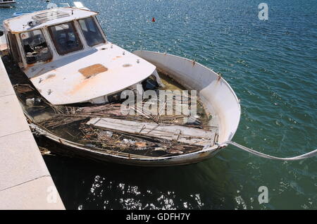 Moored Ship Sunken at Harbor Full of Debris Stock Photo