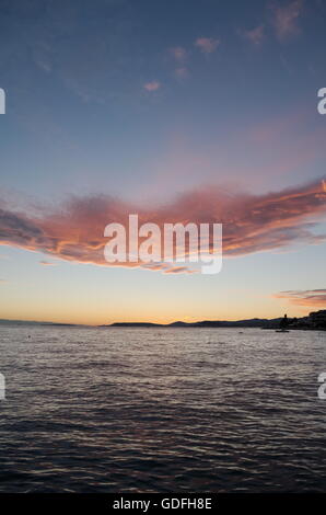 Sunset Over Split, Croatia with Calm Sea and Magical Clouds Vertical Stock Photo
