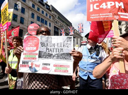 People take part in a 'No More Austerity - No To Racism - Tories Must Go' demonstration organised by the People's Assembly in central London. Stock Photo