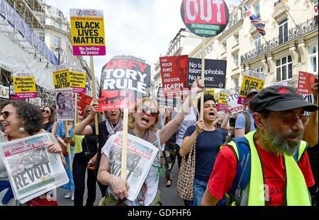 People take part in a 'No More Austerity - No To Racism - Tories Must Go' demonstration organised by the People's Assembly in central London. Stock Photo