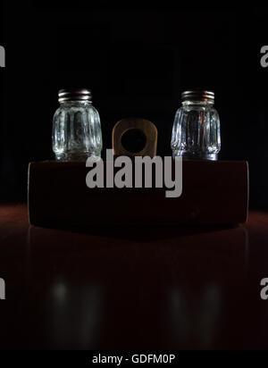 Empty salt bottles on wooden holder Stock Photo
