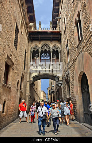 Walking in the Gothic Quarter (Barri Gotic - Carrer del Bisbe), Barcelona, Catalonia, Spain. Stock Photo