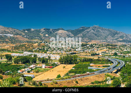 Panoramic View Of Mijas in Malaga, Andalusia, Spain. Summer Panorama Cityscape With Motorway, Highway Stock Photo