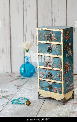 Handmade gilded mini chest of drawers in a vintage floral style Stock Photo