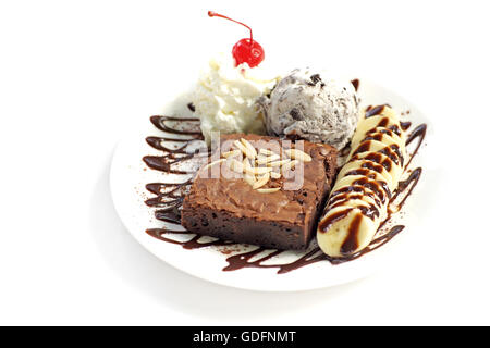 chocolate brownie with banana  ice cream and cherry on top isolated on white background Stock Photo