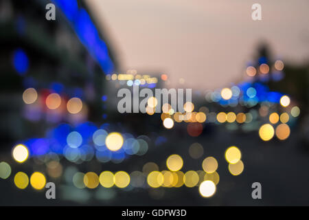 abstract background of blurred street warm, cool blue and purple city lights with bokeh effect. Stock Photo