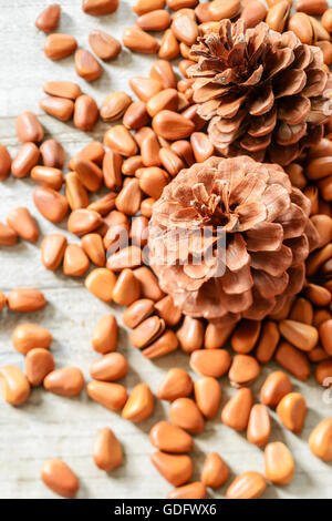 pine cones and pine nuts on the wooden board Stock Photo