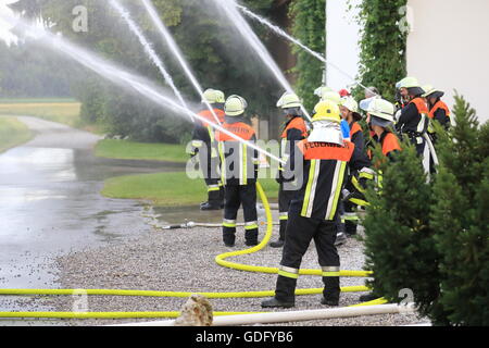 Groupt of Firefighters firemen extinguishing fire in operation Stock Photo