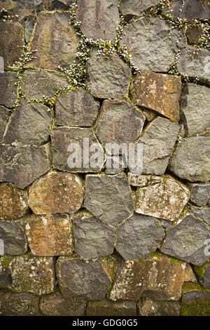 Close up of section of dry stone wall built with flat faced grey rocks Stock Photo
