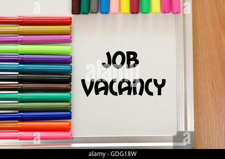 Job vacancy written on whiteboard over wooden background Stock Photo