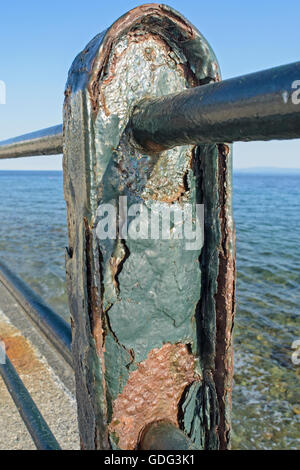 Corroded metal fence on the sea promenade. Stock Photo