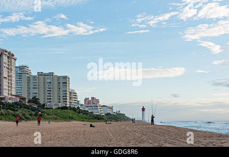 DURBAN, SOUTH AFRICA - MARCH 12, 2016: Anglers and Lifeguards on the Umhlanga Rocks beachfront with Millennium Pier and Lighthou Stock Photo