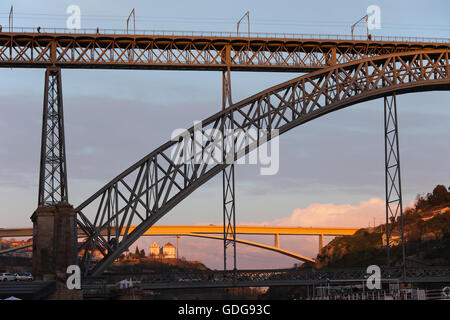 Dom Luis I Bridge between Porto and Vila Nova de Gaia in Portugal at sunset, Ponte do Infante in the background Stock Photo