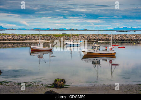 Small fishing boats anchored in calm Norwegian harbour Stock Photo