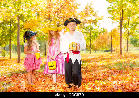 Three children in Halloween costumes together Stock Photo